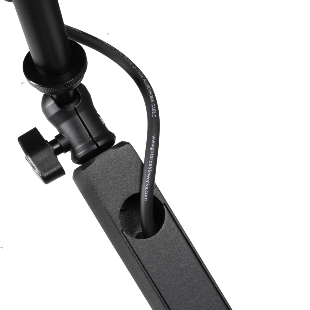 Shure SH-BROADCAST2 broadcast microphone arm mounted on a desk, adjustable with cable management, for professional audio setup.