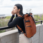 Wandrd Prvke 15L photo bundle camera bag in Sedona Orange with lifestyle setting, showcasing versatile video equipment storage.