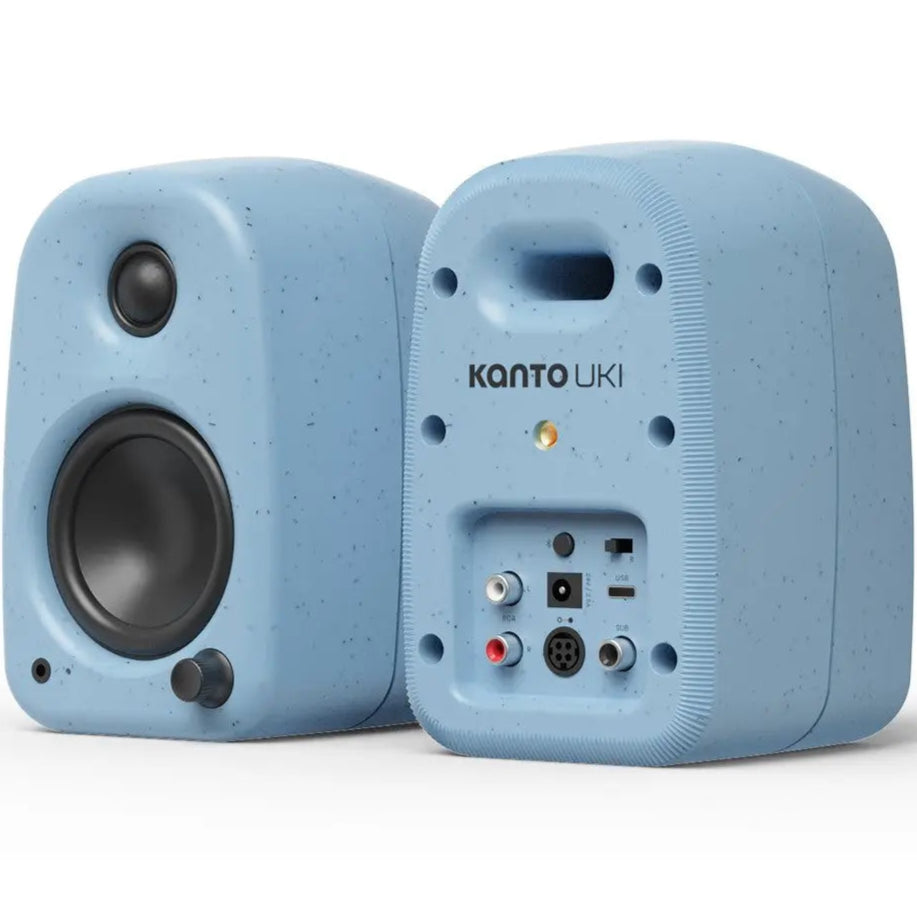 Kanto Audio UKI desktop speakers shown from dual perspectives, featuring sleek black design and compact size for desktop audio.
