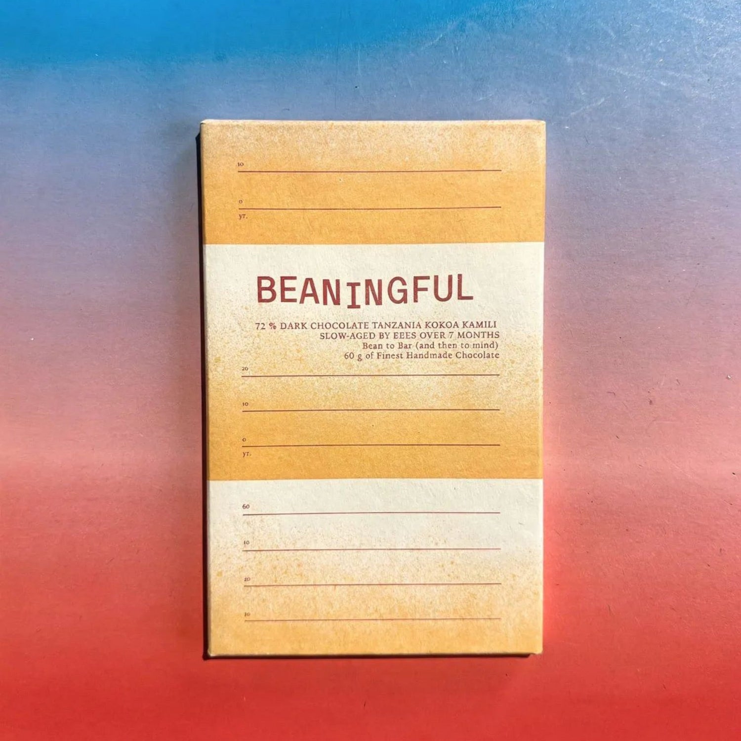 Beaningful Tanzania 72% dark chocolate bar with beehive label, showcasing the packaging and rich chocolate texture in close-up.