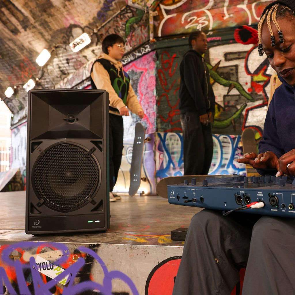 AlphaTheta Wave-Eight battery-powered loudspeakers with sleek black design and control buttons on top.