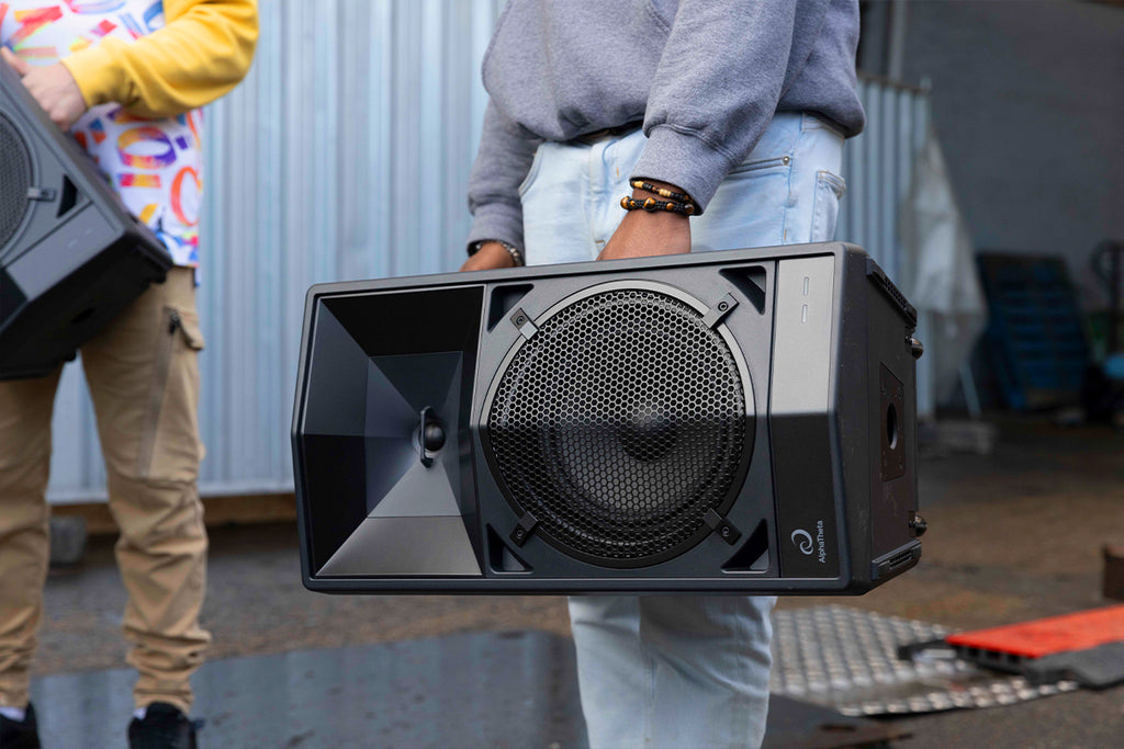 AlphaTheta Wave-Eight battery-powered loudspeakers shown in a lifestyle setting with modern design and portable setup.