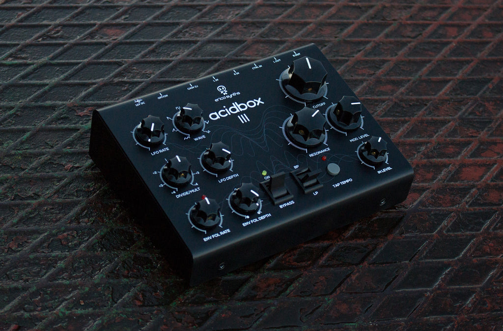 Erica Synths Acidbox III effects pedal with colorful control knobs and input/output jacks for synthesizer processing.