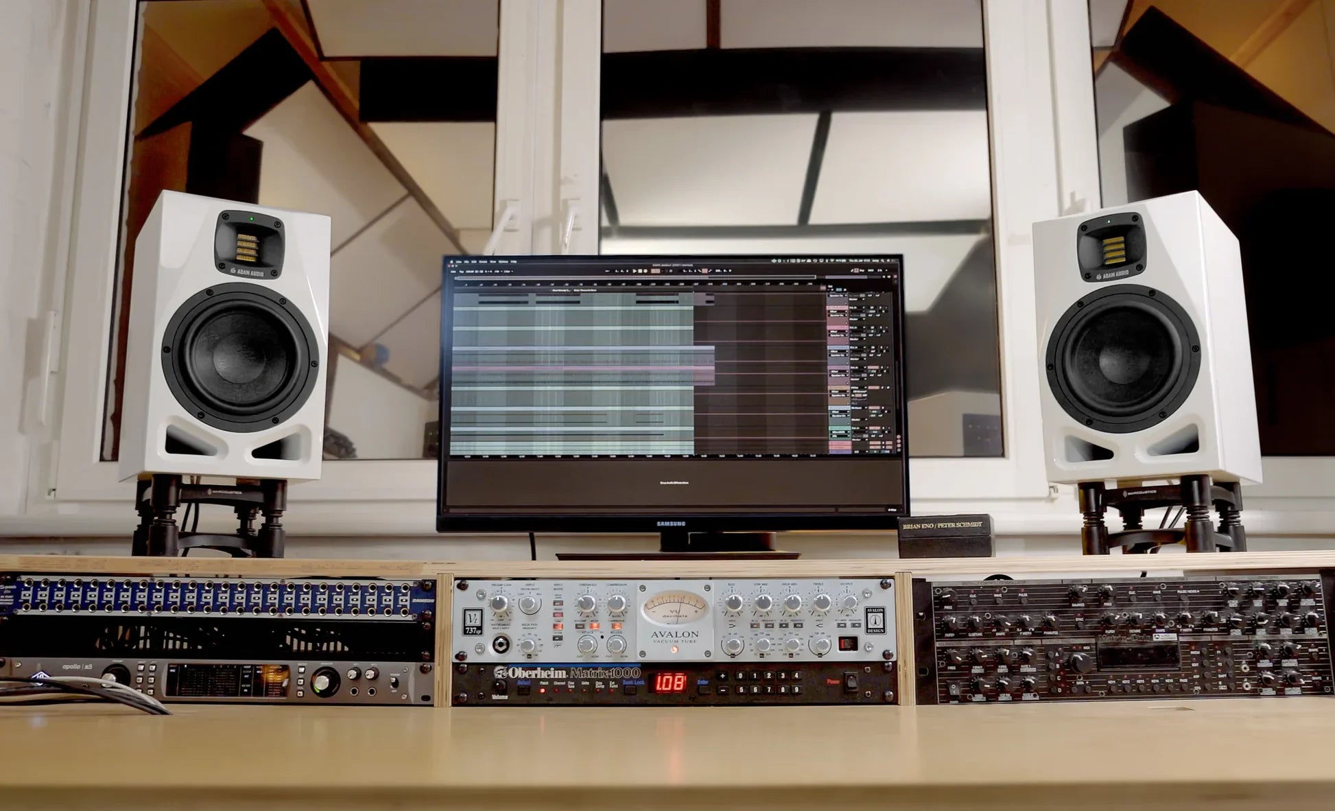 Pair of Adam Audio A7V active nearfield studio monitors on a desk, celebrating the 25th anniversary edition.