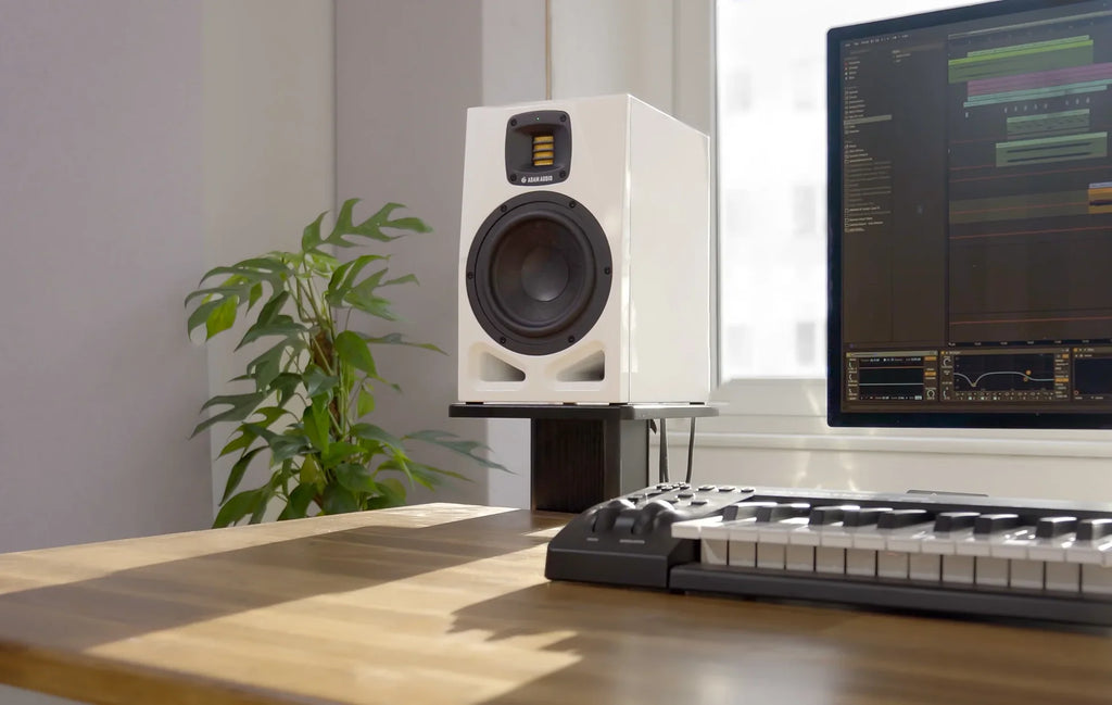 Adam Audio A7V active nearfield studio monitor speakers, 25th anniversary limited edition on a desk.