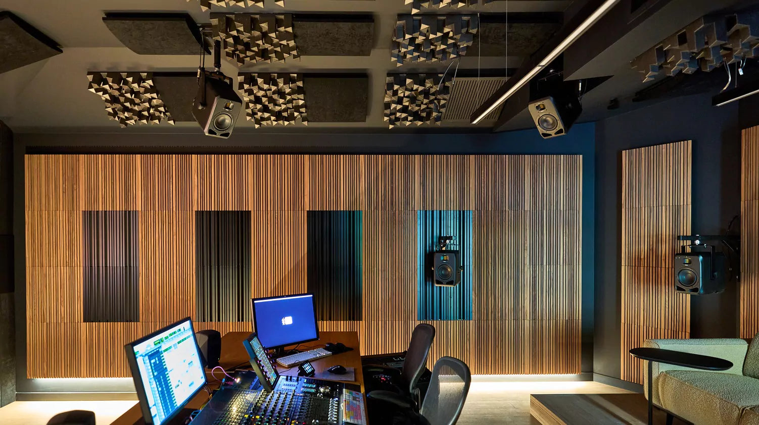 Adam Audio S2V mid-field main studio monitors shown in a professional studio setting with sleek black cabinets and detailed drivers.