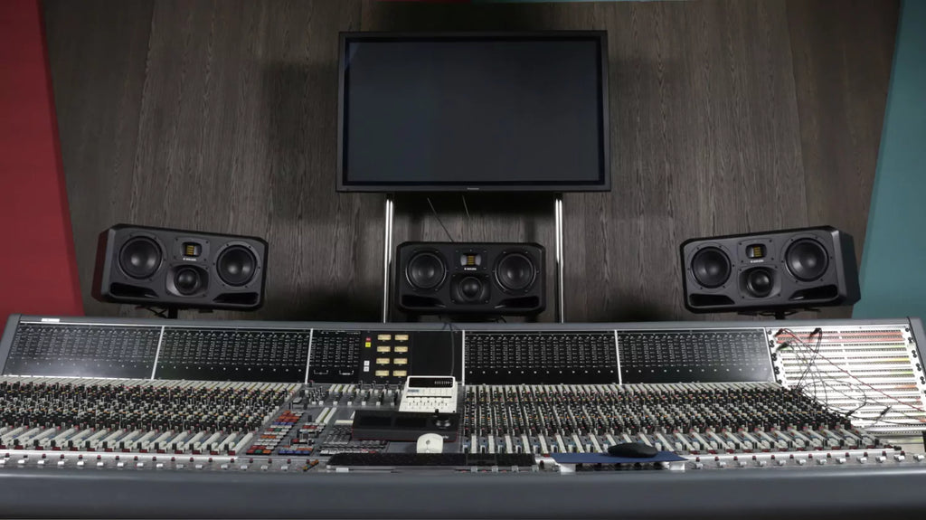 Adam Audio S3H studio monitor speakers shown in a professional music production studio setup.