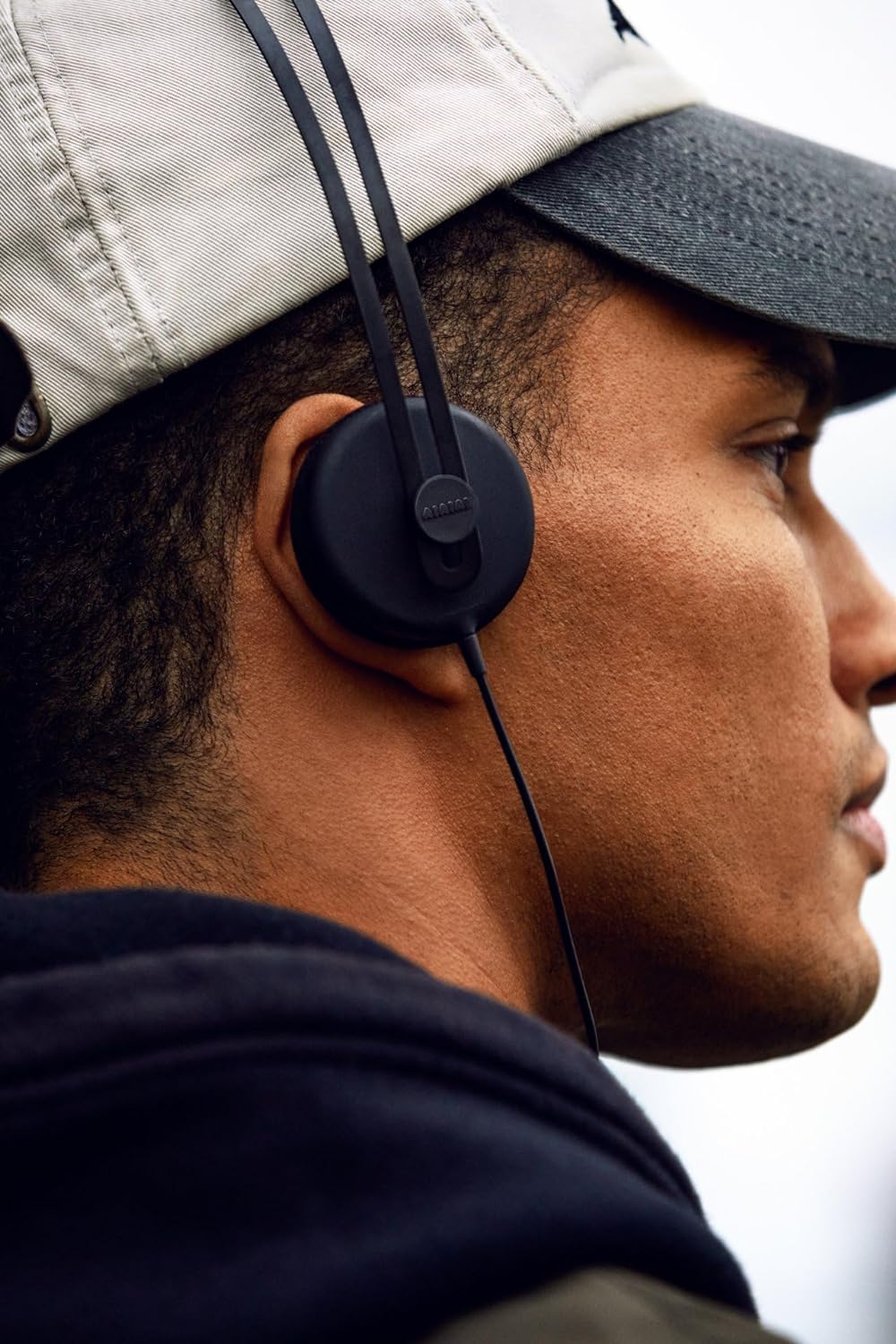 AIAIAI Tracks wired headphones in black, lifestyle worn close-up