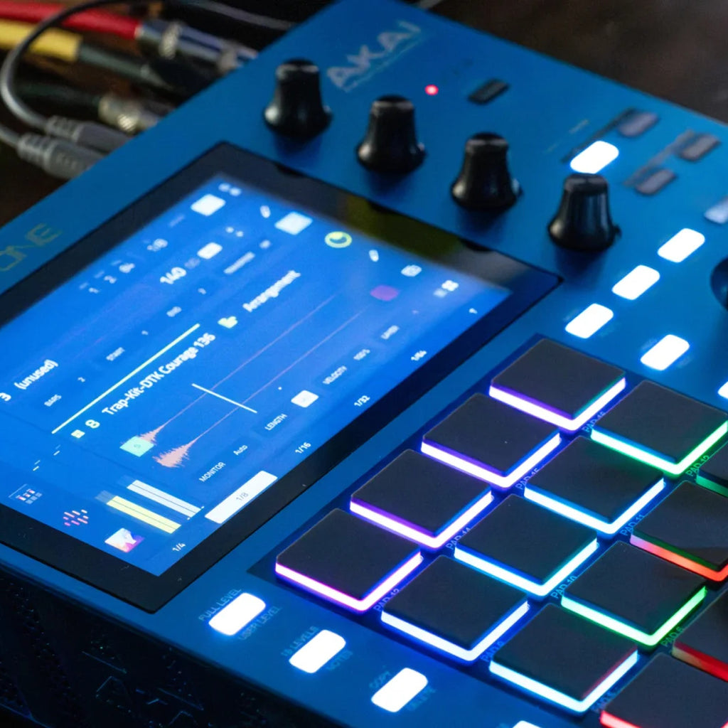 Akai Professional MPC One G2 played on a studio desk, hands on the RGB pads