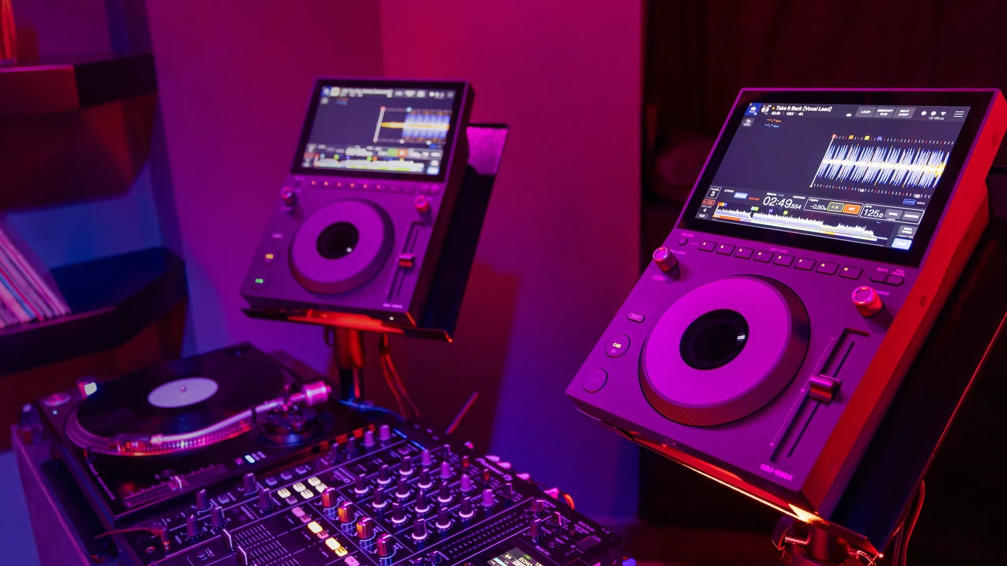 AlphaTheta CDJ-1500X DJ media players in a club booth