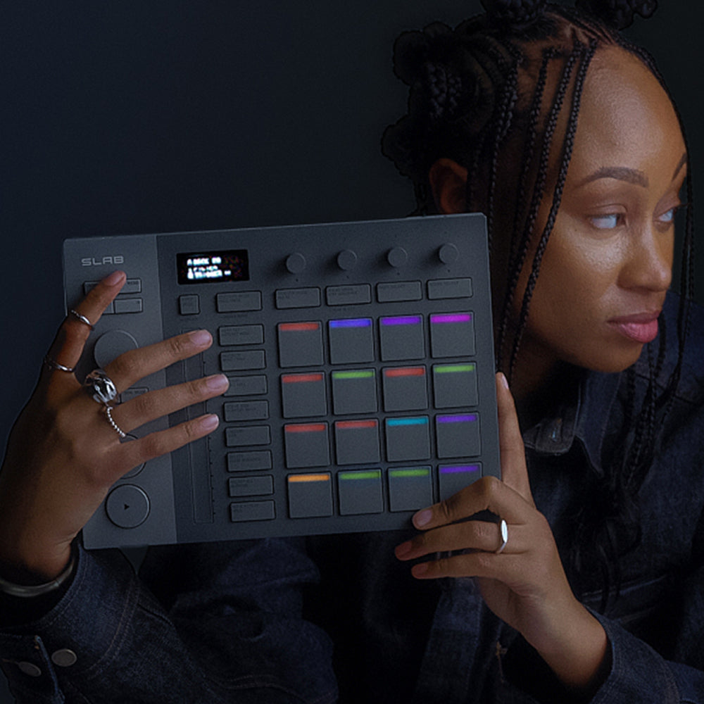 AlphaTheta SLAB MIDI controller with a sleek black top surface and multiple control knobs and pads for music production.