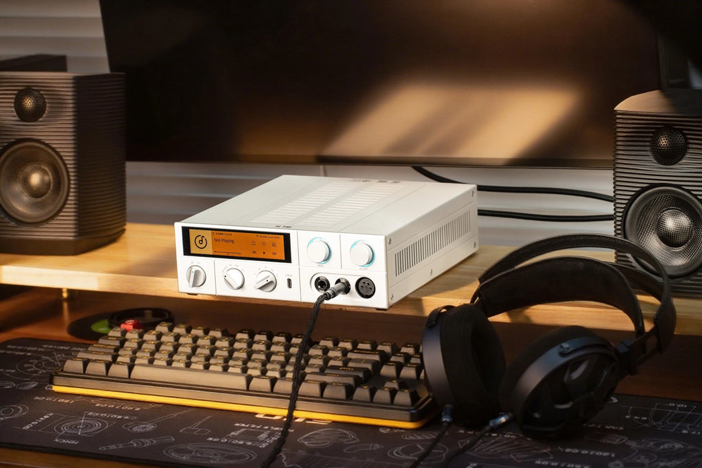 FiiO K15 desktop headphone amplifier and DAC with digital display, black finish, and multiple input options.
