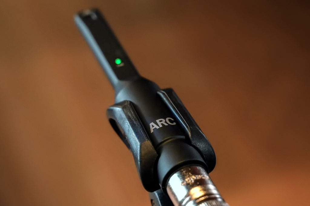 IK Multimedia ARC X room calibration software with measurement microphone, used for acoustic room analysis and calibration.