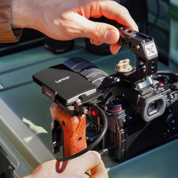 Lexar Armor 700 Portable SSD external drive with rugged design and high-speed data transfer, shown in black with textured surface.