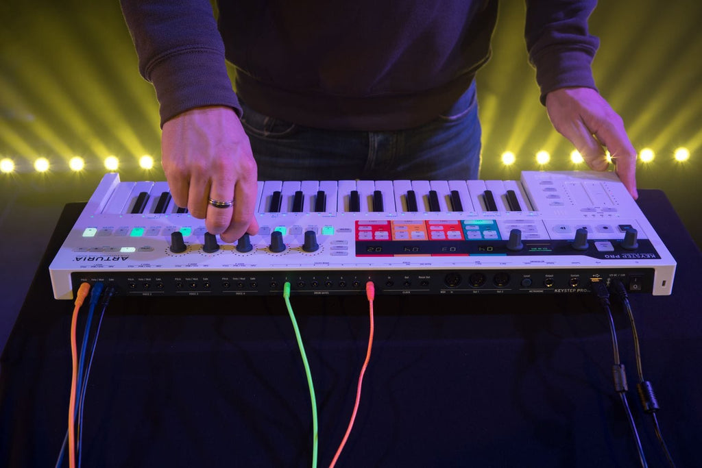 Arturia Keystep Pro sequencer device with multiple knobs, buttons, and a compact keyboard for music production and live performance.