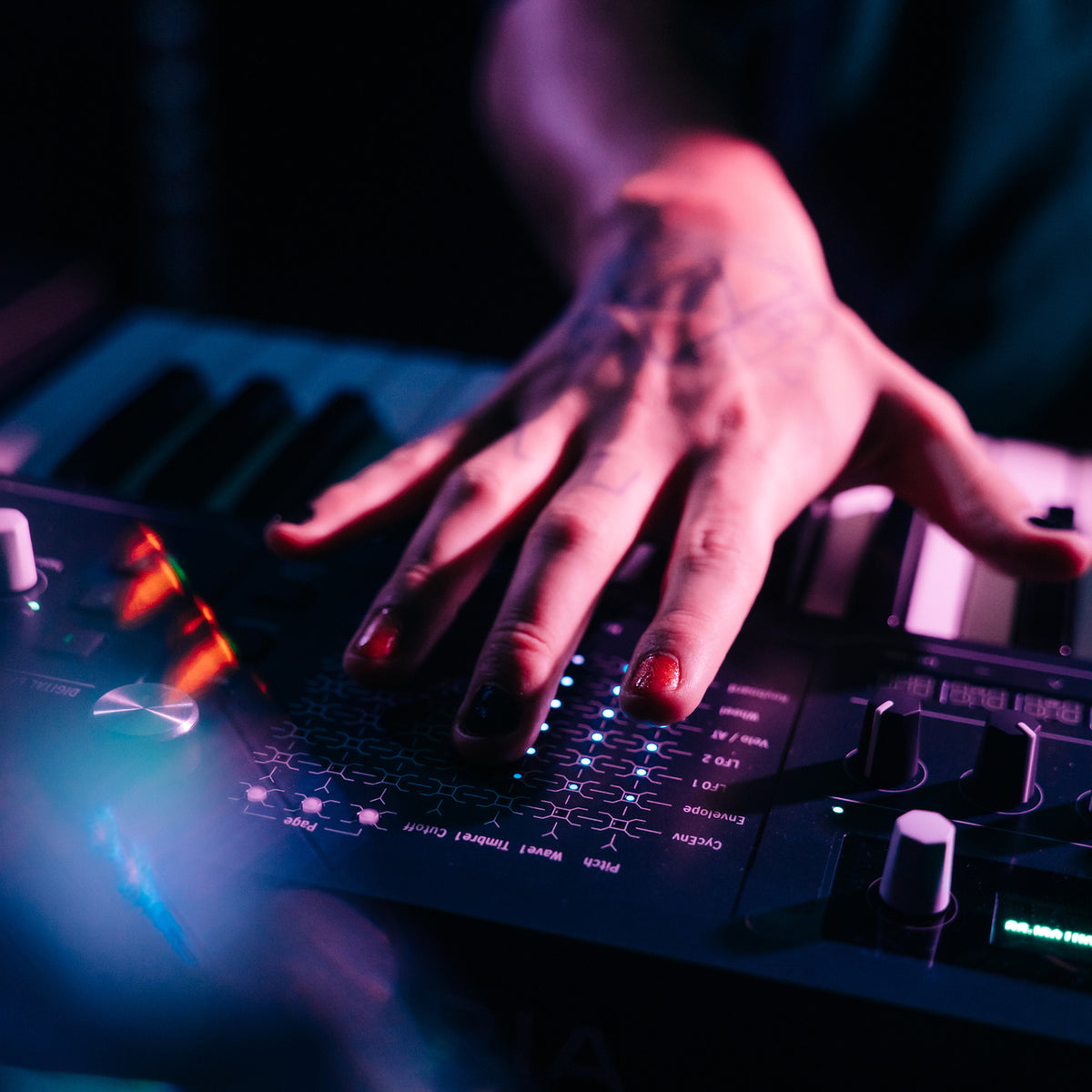 Close-up of hand performing on the Arturia MiniFreak 49 illuminated XYZ touch matrix