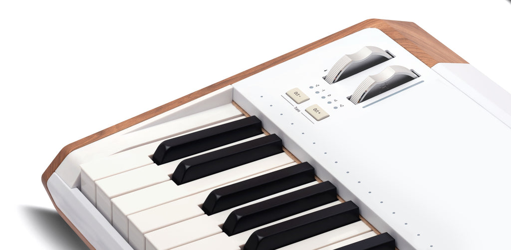 Arturia AstroLab 61 performance keyboard with white keys, zoom wheels, and control knobs, showcasing its sleek design.
