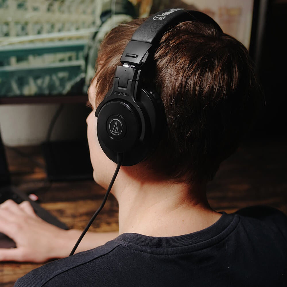 Audio-Technica ATH-M30x studio headphones, lifestyle worn at a desk