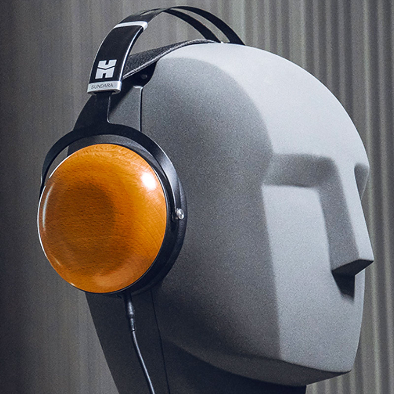 HiFiMAN Sundara closed-back wired headphones with large ear cups and black design, detailed view of the audio equipment.
