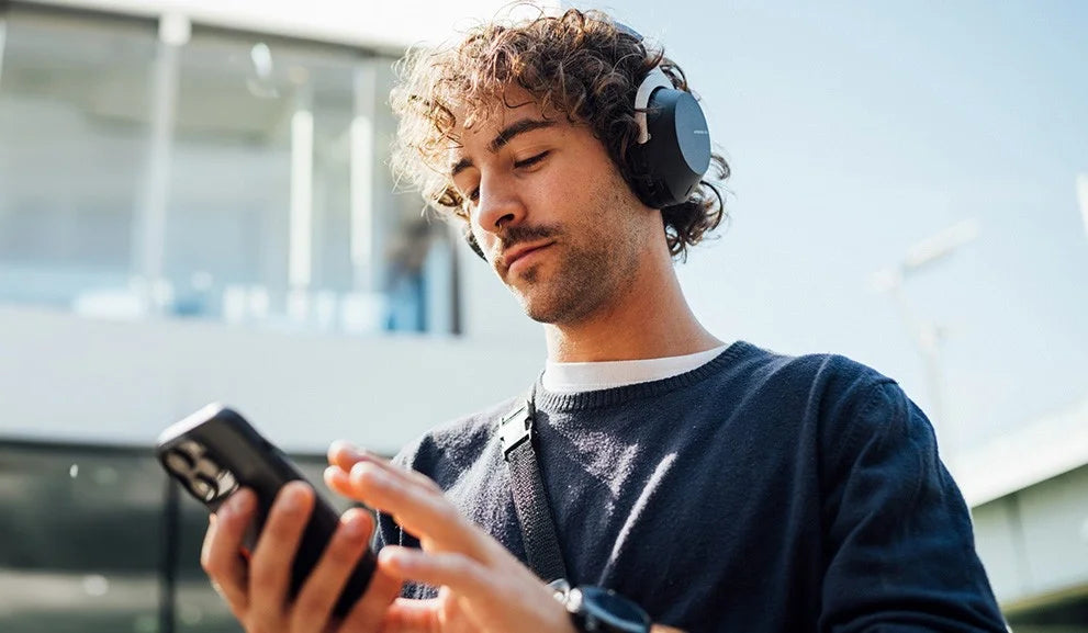Beyerdynamic Aventho 300 wireless headphones with over-ear design and sleek black finish, positioned on a display banner.