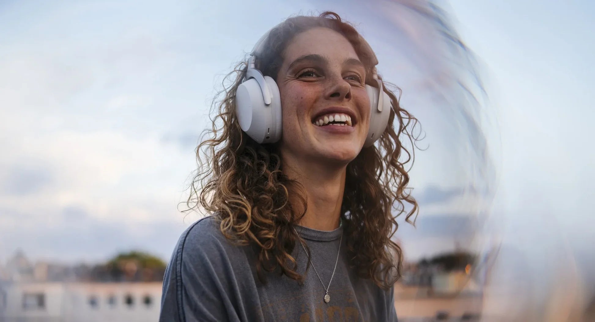 Beyerdynamic Aventho 300 wireless headphones worn by a dancing girl, showcasing sleek design and comfortable fit.