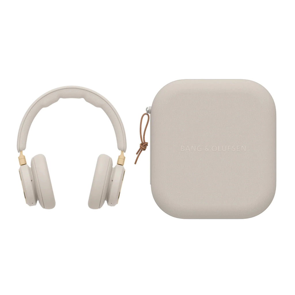 Gold-tone Bang & Olufsen Beoplay HX wireless headphones with carrying case, sleek design and premium audio quality.