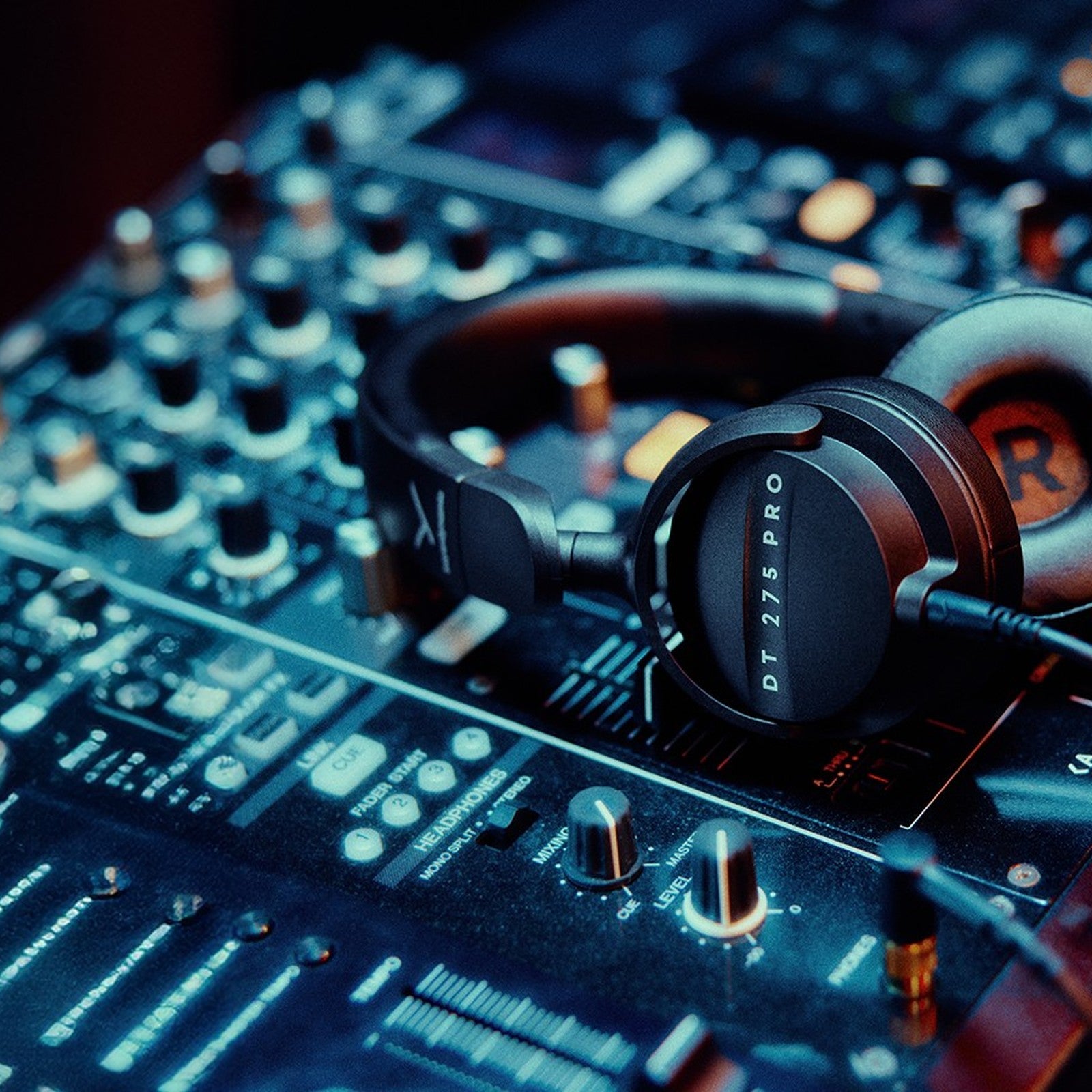 Beyerdynamic DT 275 PRO headphones resting on a DJ mixer