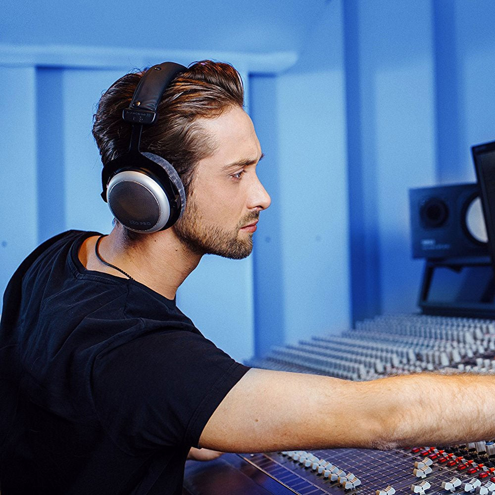 Beyerdynamic DT 880 Pro studio headphones with open-back design and 250 ohm impedance, resting on a white background.