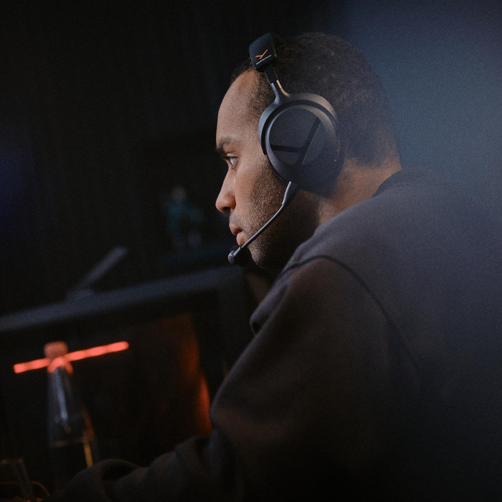 Player using the Beyerdynamic MMX 100 Wireless headset in a dark gaming room
