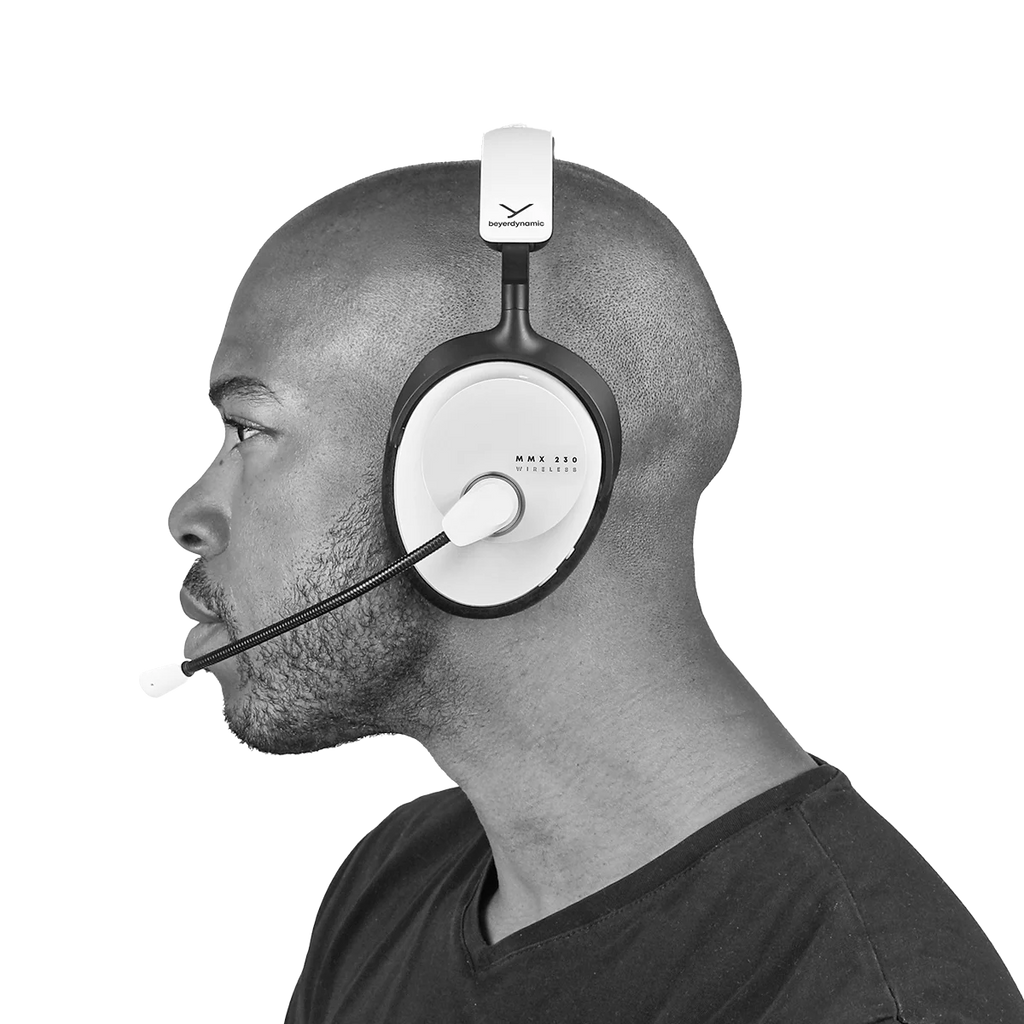 Beyerdynamic MMX 230 Wireless gaming headphones in white with over-ear design and built-in microphone, worn by a person.