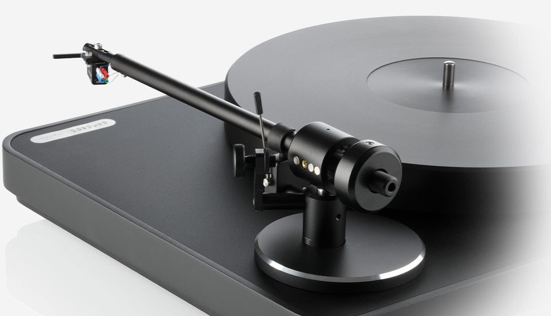 Close-up of the black Clearaudio Concept Signature manual turntable showing the tonearm and platter details.