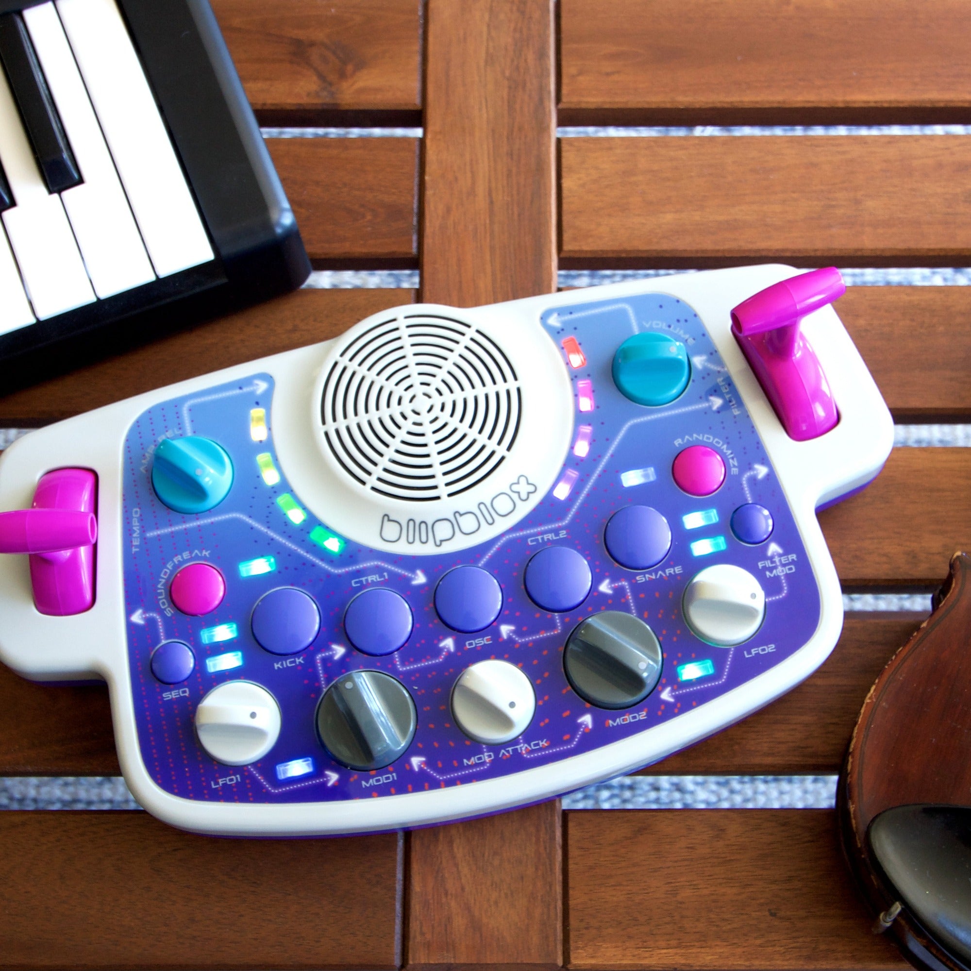 Blipblox SK2 on a table beside a MIDI keyboard
