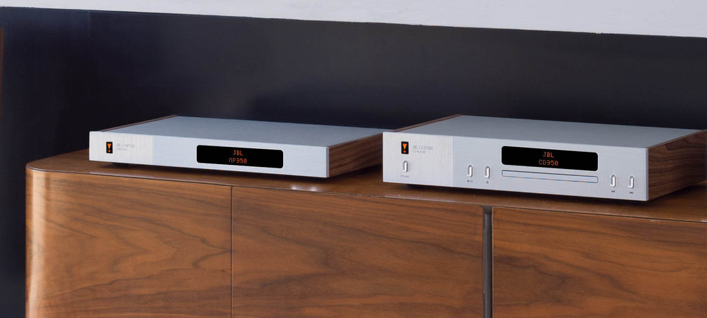 JBL CD350 Classic CD player on a desk, featuring a sleek design with a digital display and control buttons.