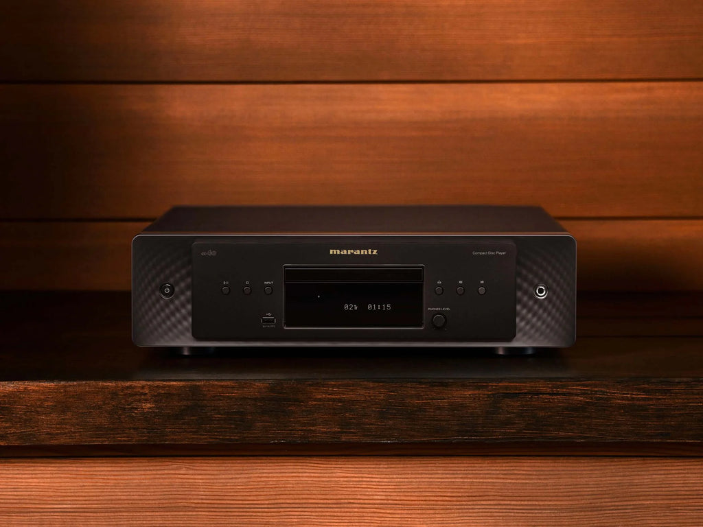Marantz CD 60 black CD player with sleek design, showing top view and front display on a studio surface.