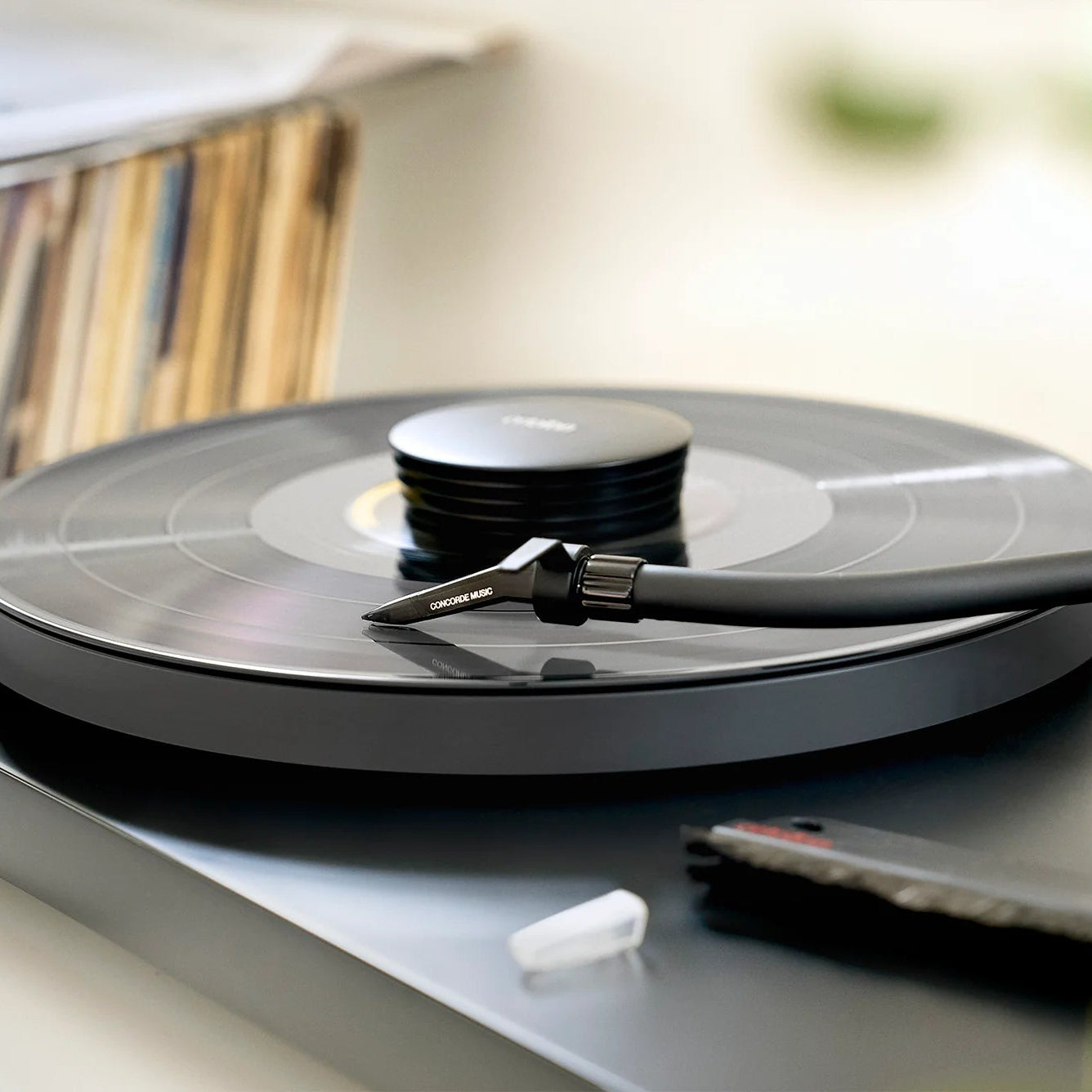 Ortofon Concorde Music Black turntable cartridge mounted on a Pro-Ject turntable with a sleek black design.