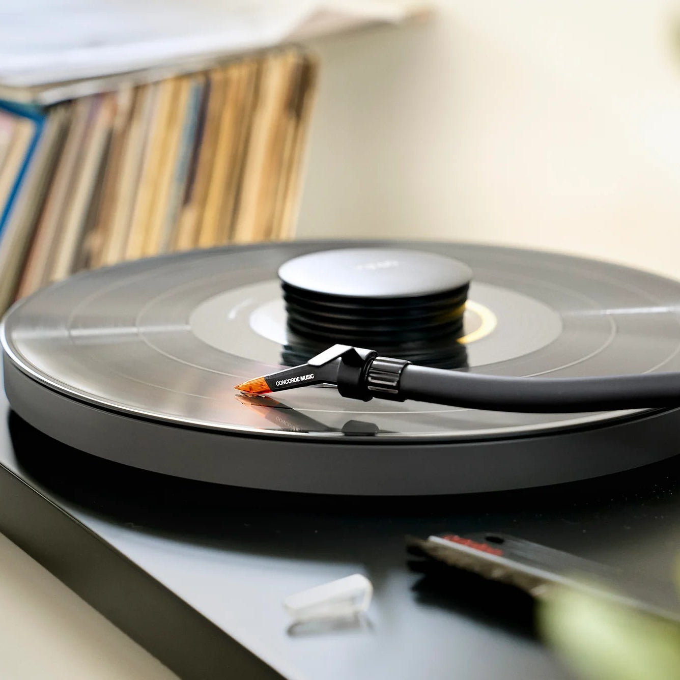 Ortofon Concorde Music Bronze turntable cartridge mounted on a Pro-Ject turntable, showcasing its sleek bronze finish and stylus.