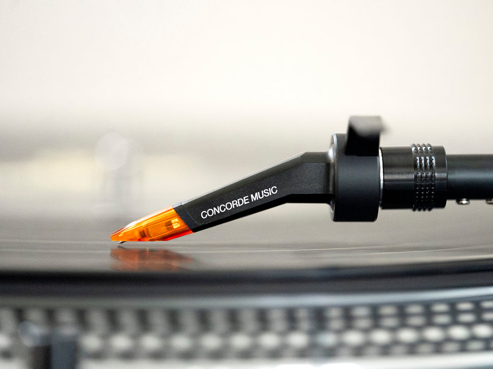 Ortofon Concorde Music Bronze turntable cartridge mounted on Technics turntable, showcasing detailed stylus and cartridge design.