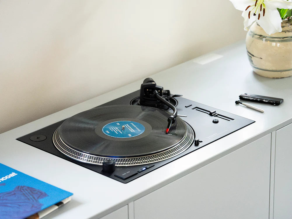 Ortofon Concorde Music Red cartridge mounted on a Technics turntable, close-up view of the stylus and cartridge body.