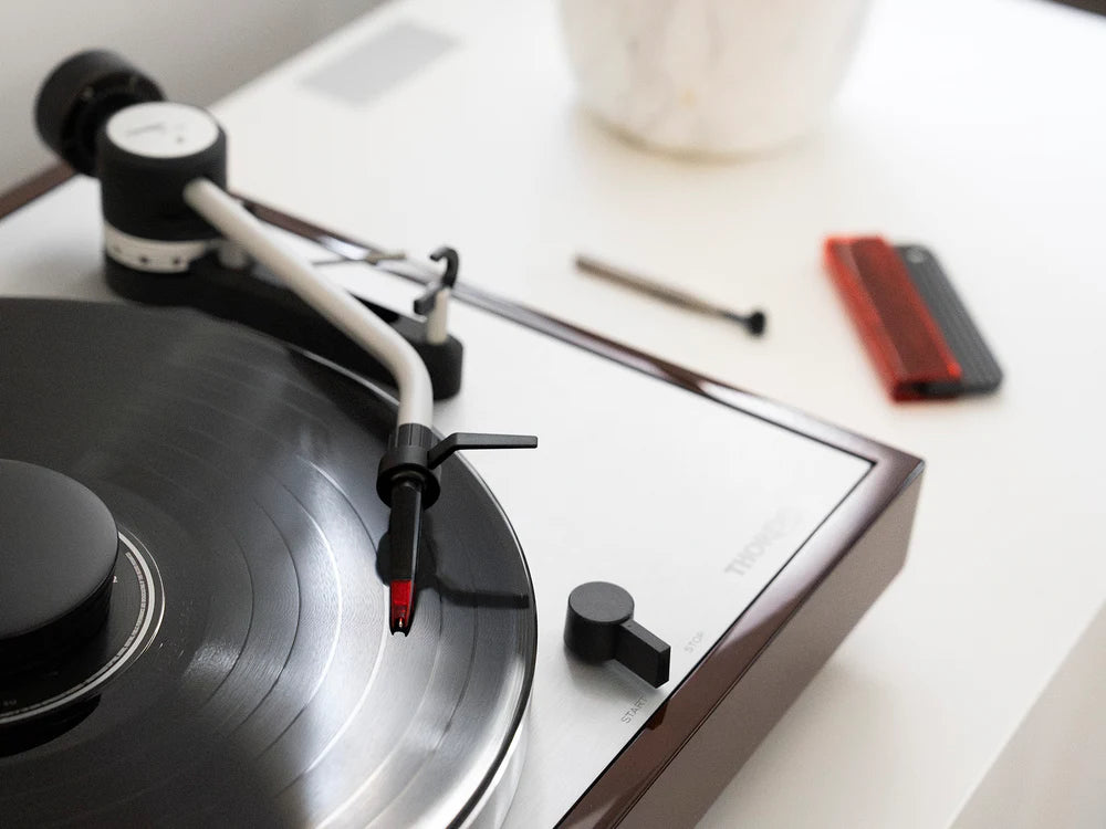 Ortofon Concorde Music Red turntable cartridge mounted on Thorens turntable, showing the sleek red stylus and cartridge body.
