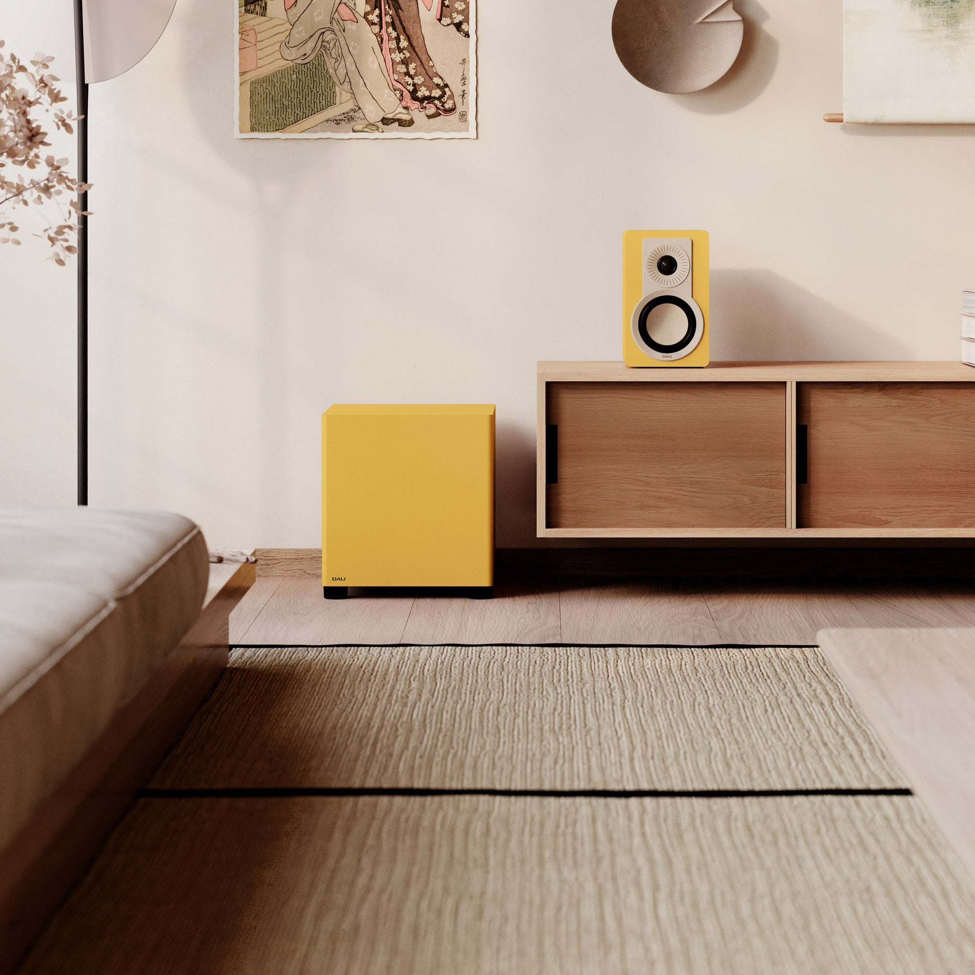 Dali Basik Sub in Golden Yellow placed beside an oak sideboard in a minimal interior