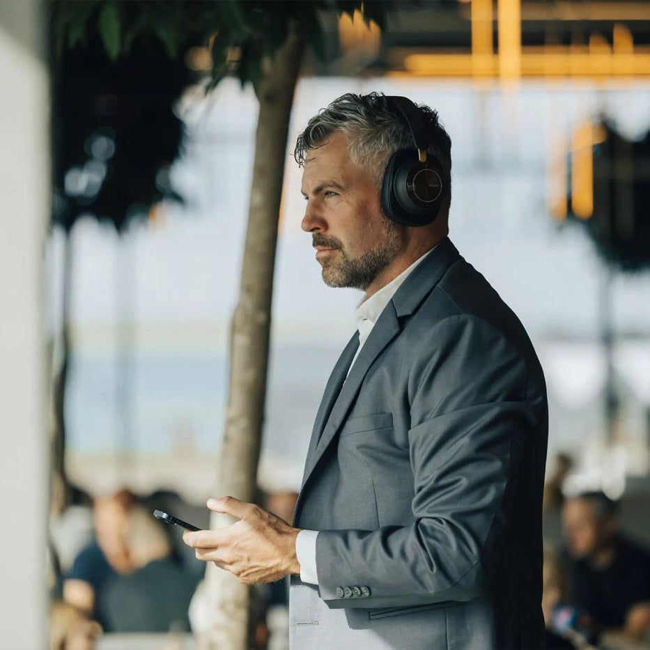 DALI Dali iO-12 wireless headphones with black ear cups and headband, showing the sleek design and ear cushions.