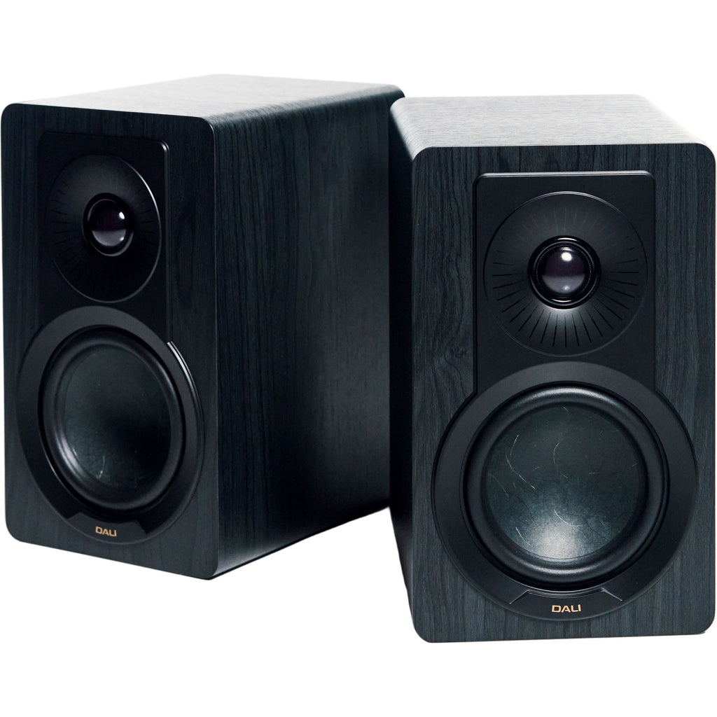 DALI Kupid passive bookshelf speakers shown with sleek black cabinets and compact design for high-quality audio performance.