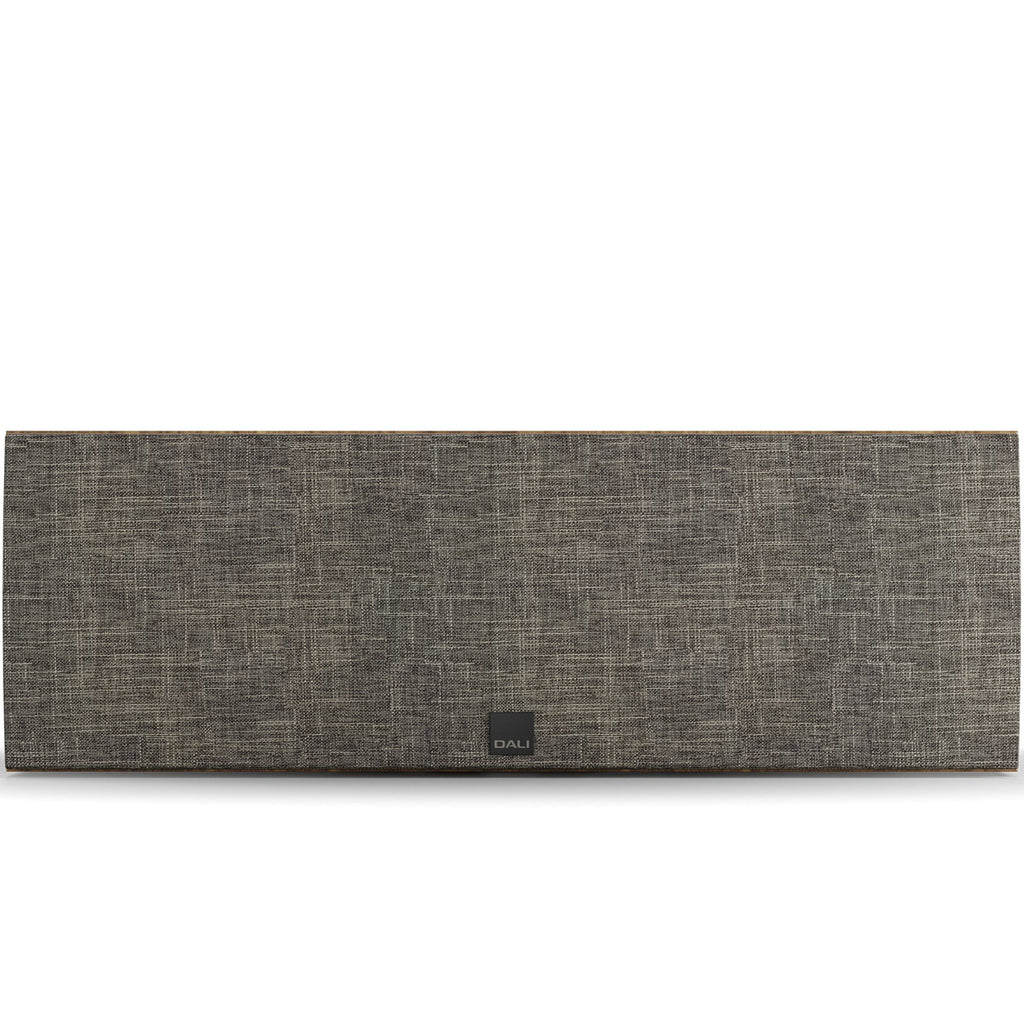 DALI Rubikore Cinema center speaker in natural walnut finish, showcasing sleek design and front grille for home theater audio.