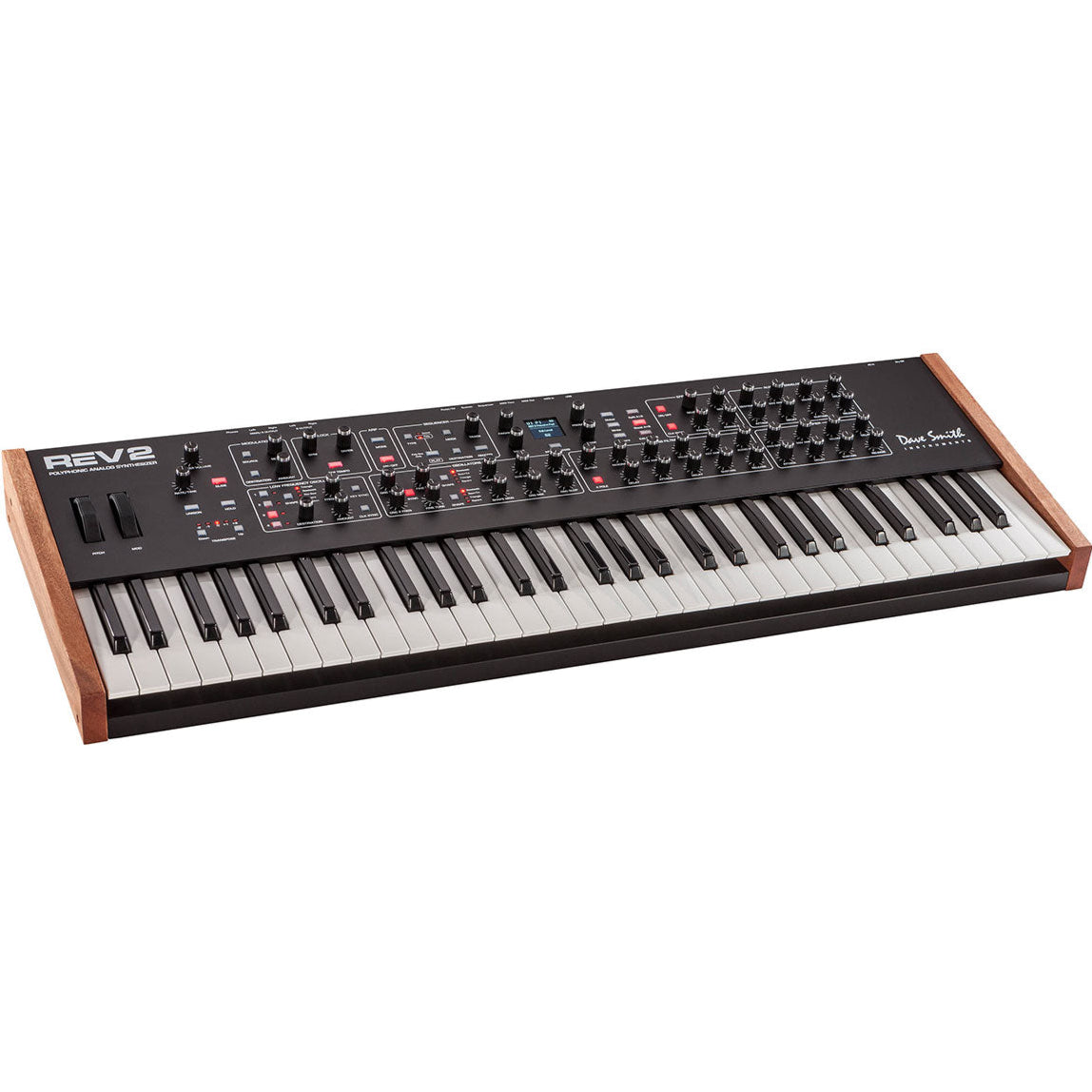 Sequential Prophet Rev2-16 synthesizer with 16-voice polyphony and control knobs, displayed on a stand in a music studio.