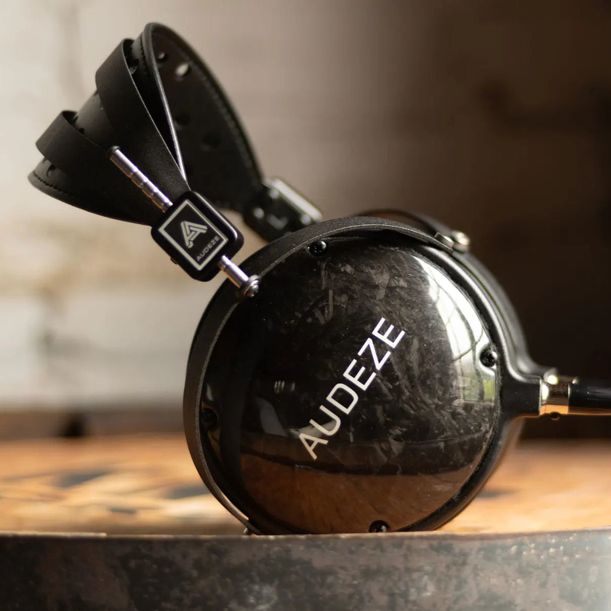 Audeze LCD-2 Classic closed-back leather-free Head-fi headphones with black ear cups and headband, showing sleek design and ear cushions.