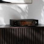 Eversolo DMP-A8 Gen 2 on a dark wood sideboard with VU meters lit