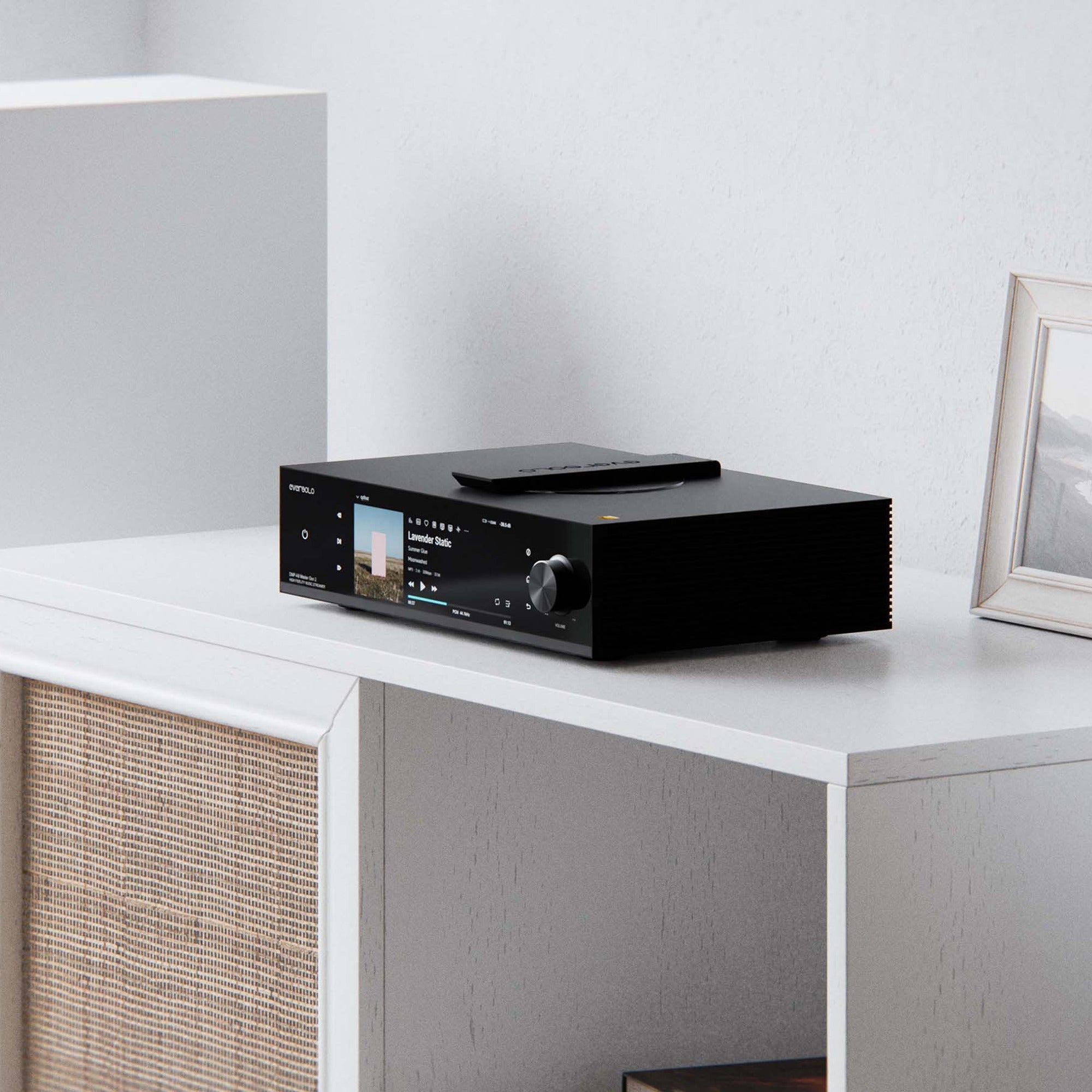 Eversolo DMP-A8 Master Edition Gen 2 on a white shelf beside a loudspeaker