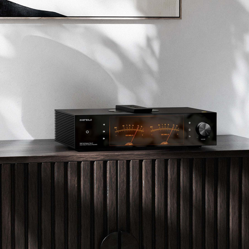 Eversolo DMP-A8 Master Edition Gen 2 on a dark wood sideboard with VU meters lit