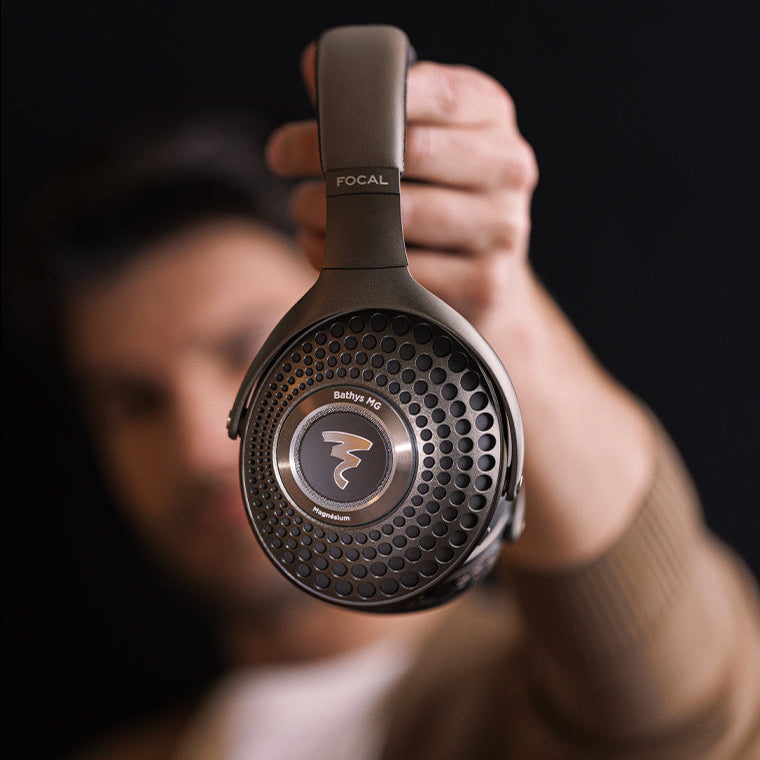 Focal Bathys MG wireless headphones with over-ear design, showing sleek black ear cups and headband against a neutral background.