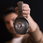 Focal Bathys MG wireless headphones with over-ear design, showing sleek black ear cups and headband against a neutral background.